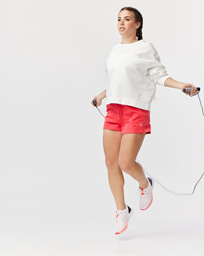 Goal Five G5 Advance 4.5-inch knit shorts in hot coral, showing the textured fabric and casual fit on a model.