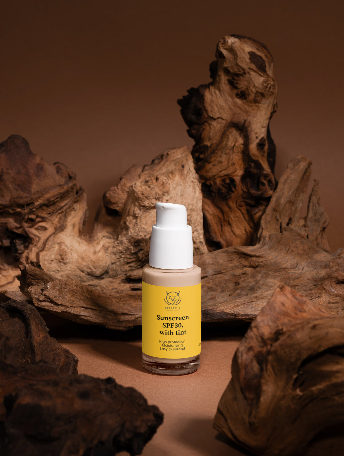 BelleVie Cosmétiques tinted mineral sunscreen SPF 30 with natural glow, showing the tube and a smooth, glowing skin finish.
