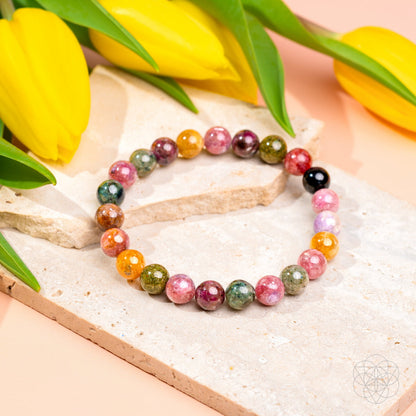 Rainbow tourmaline bracelet called The Spiral Breaker by Conscious Items featuring colorful, polished gemstone beads on a flexible bracelet.
