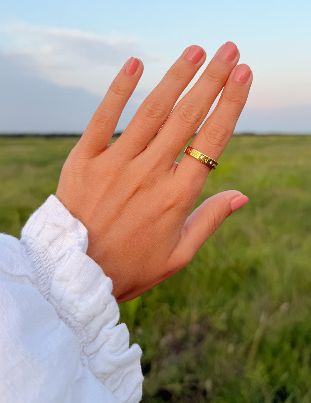 Elevated Faith gemstone logo ring featuring a polished band with a central gemstone and engraved logo design.
