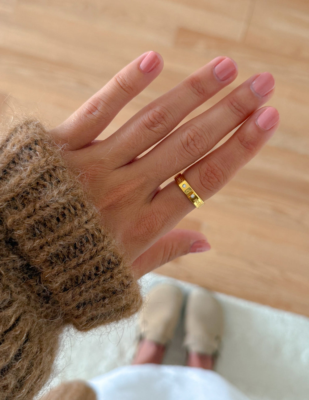 Elevated Faith gemstone logo ring featuring a polished band with a prominent gemstone logo design on top.