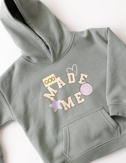 Kids hoodie by Elevated Faith featuring "God Made Me" design, soft fabric, and comfortable fit for children.