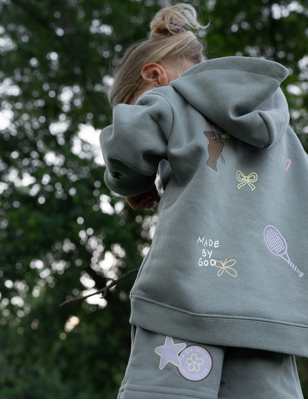 Brightly colored kids hoodie featuring "God Made Me" design by Elevated Faith, perfect for children’s casual wear.