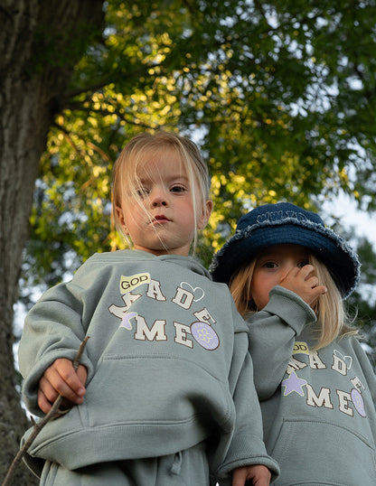 Kids hoodie by Elevated Faith featuring a "God Made Me" design, soft fabric, and comfortable fit for children.