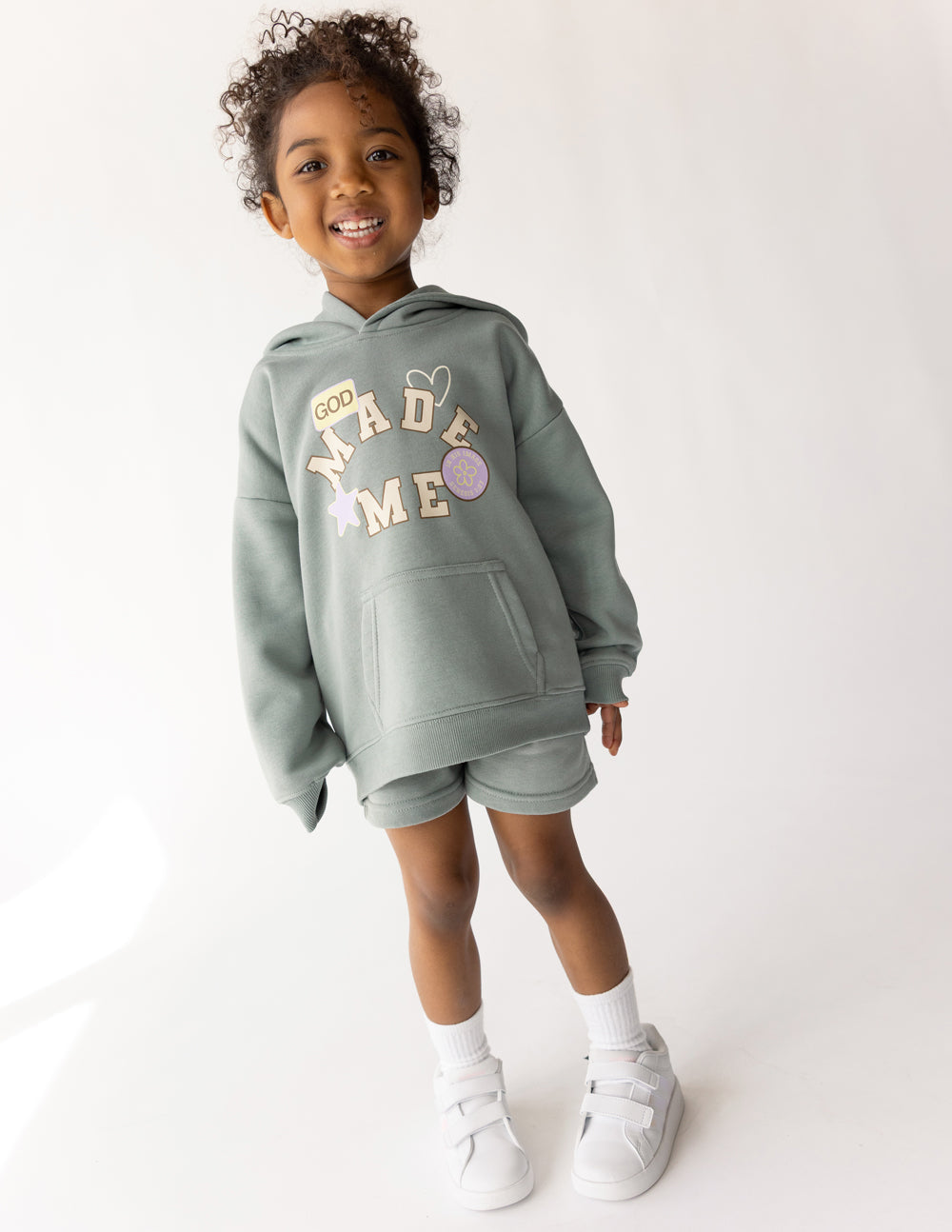Kids shorts featuring a "God Made Me" design from Elevated Faith, made for children, with colorful fabric and comfortable fit.