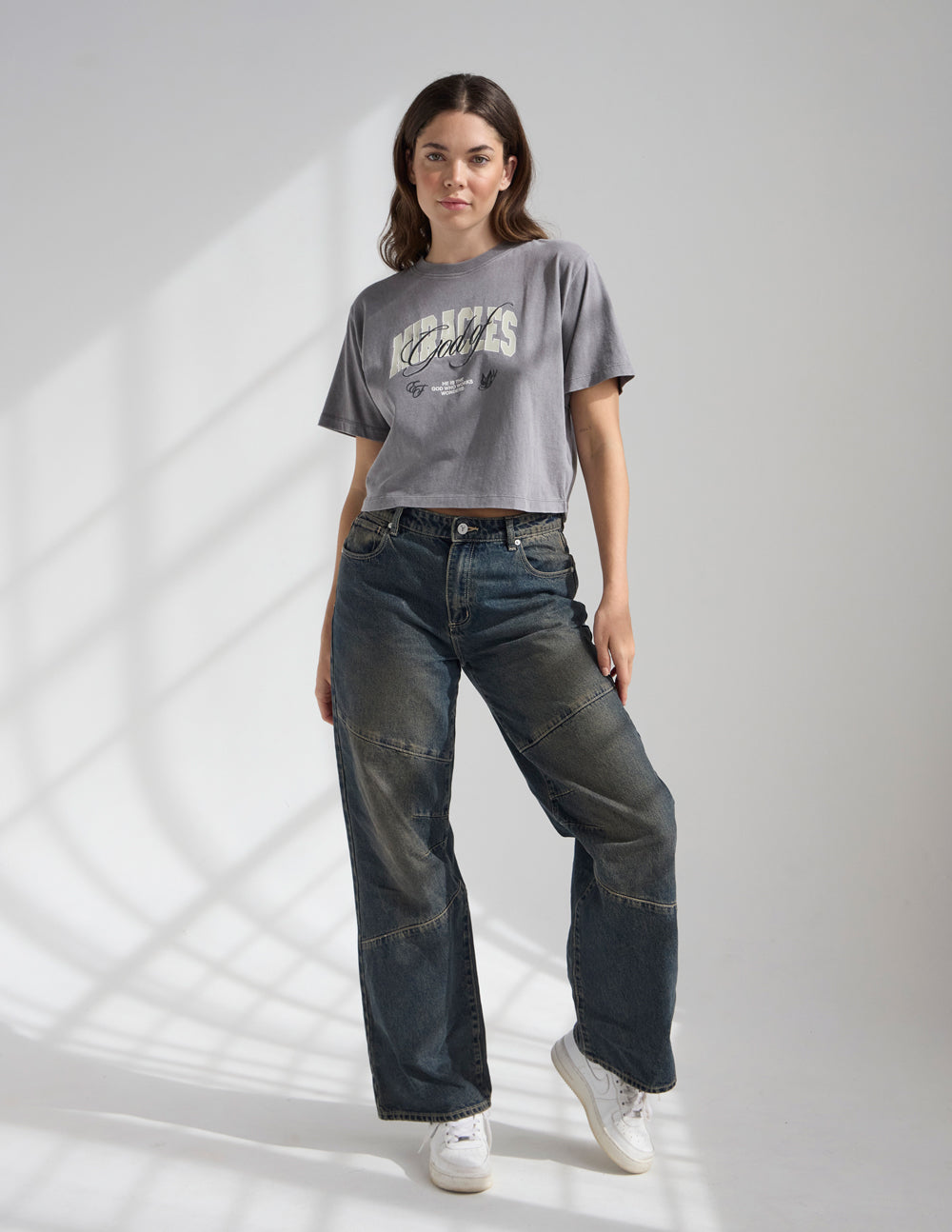 Cropped women's T-shirt by Elevated Faith featuring a religious graphic design inspired by the God of Miracles.