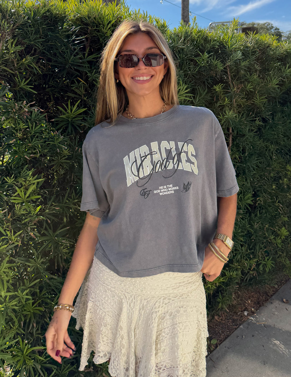 Elevated Faith God of Miracles cropped women's T-shirt with biblical design, white short sleeve tee for casual wear.