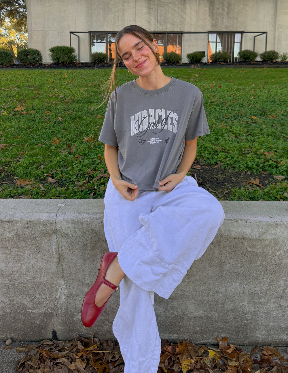 Cropped women's T-shirt by Elevated Faith featuring a God of Miracles graphic design and religious-inspired artwork.