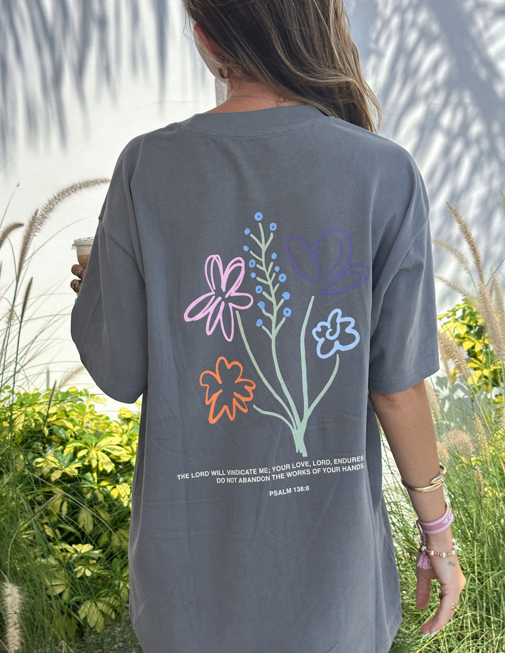 Unisex T-shirt with "God's Still Working" print by Elevated Faith, featuring a comfortable fit and faith-inspired design.