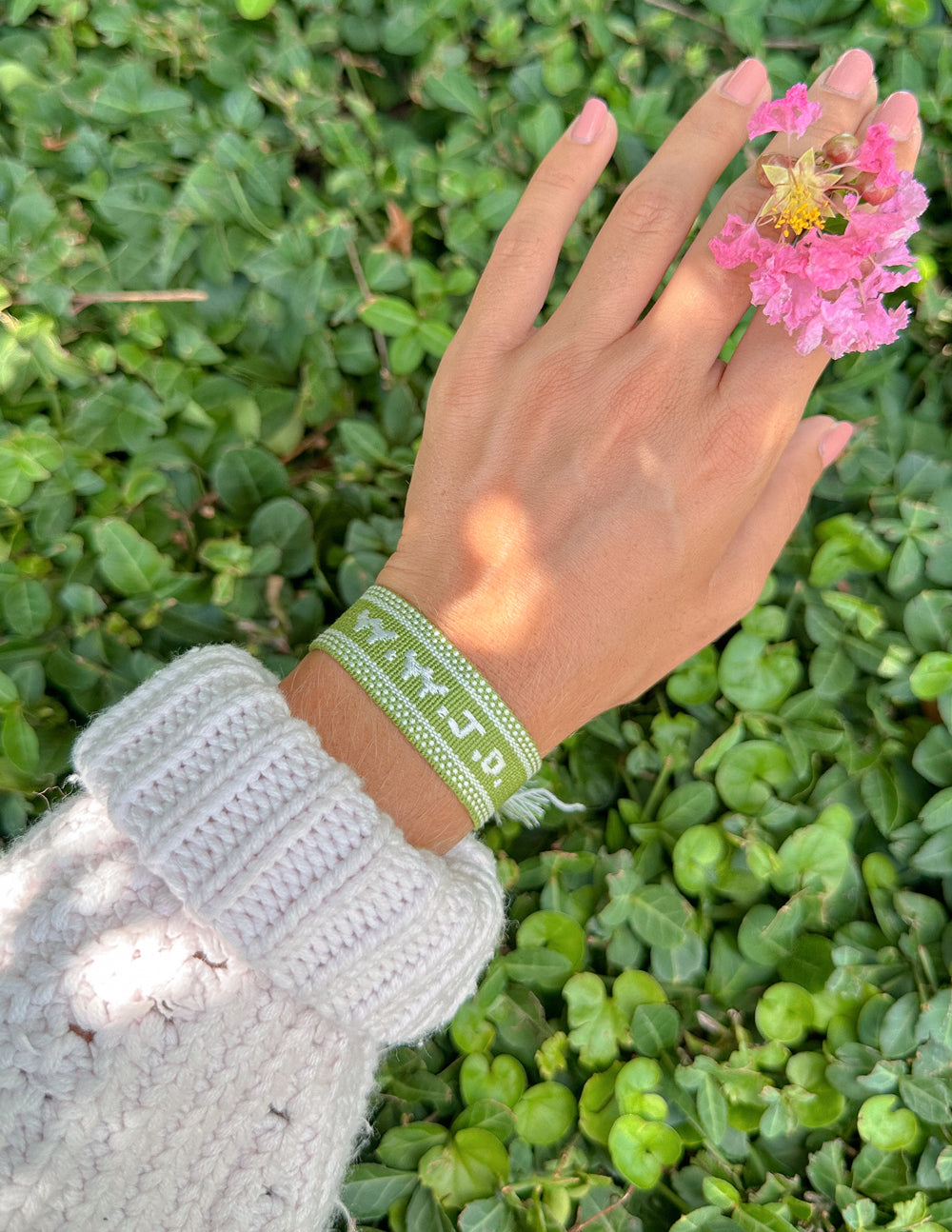 Green WWJD embroidered bracelet wristband by Elevated Faith with visible stitching and embroidered lettering on fabric.
