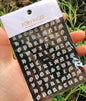 Black Old English font nail art stickers featuring alphabet letter transfers for gothic and gothic-inspired nail decoration.