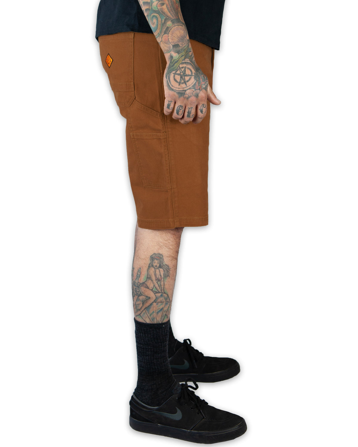 Off The Grid Surplus Havok Shorts 12-inch in tobacco color, featuring durable fabric and relaxed fit, shown on a model.