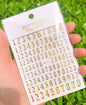 Black Old English font nail art stickers with alphabet letters, decorative transfers from Blushimmer for gothic nail decoration.