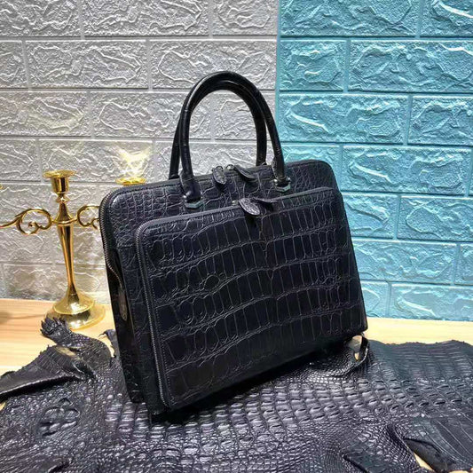 Black crocodile belly leather handbag for men by Don John, featuring a sleek design and sturdy handle.