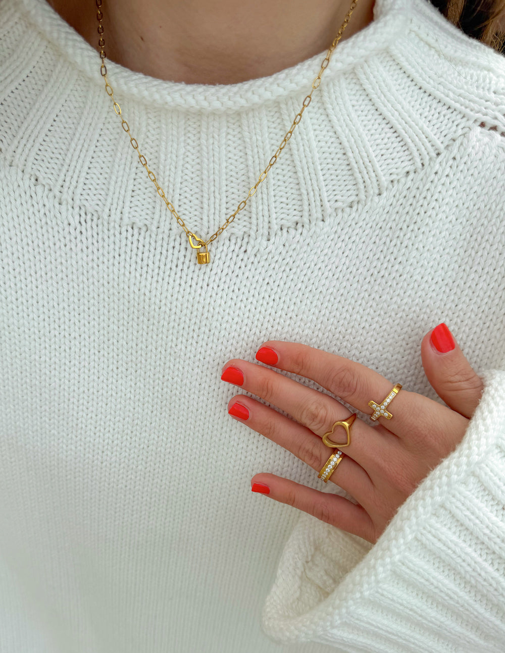 Elevated Faith heart lock paperclip chain necklace with a delicate pendant, featuring a modern jewelry design.
