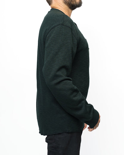Vintage black Draper Henley long sleeve shirt by Off The Grid Surplus, displayed on a hanger with a casual fit.