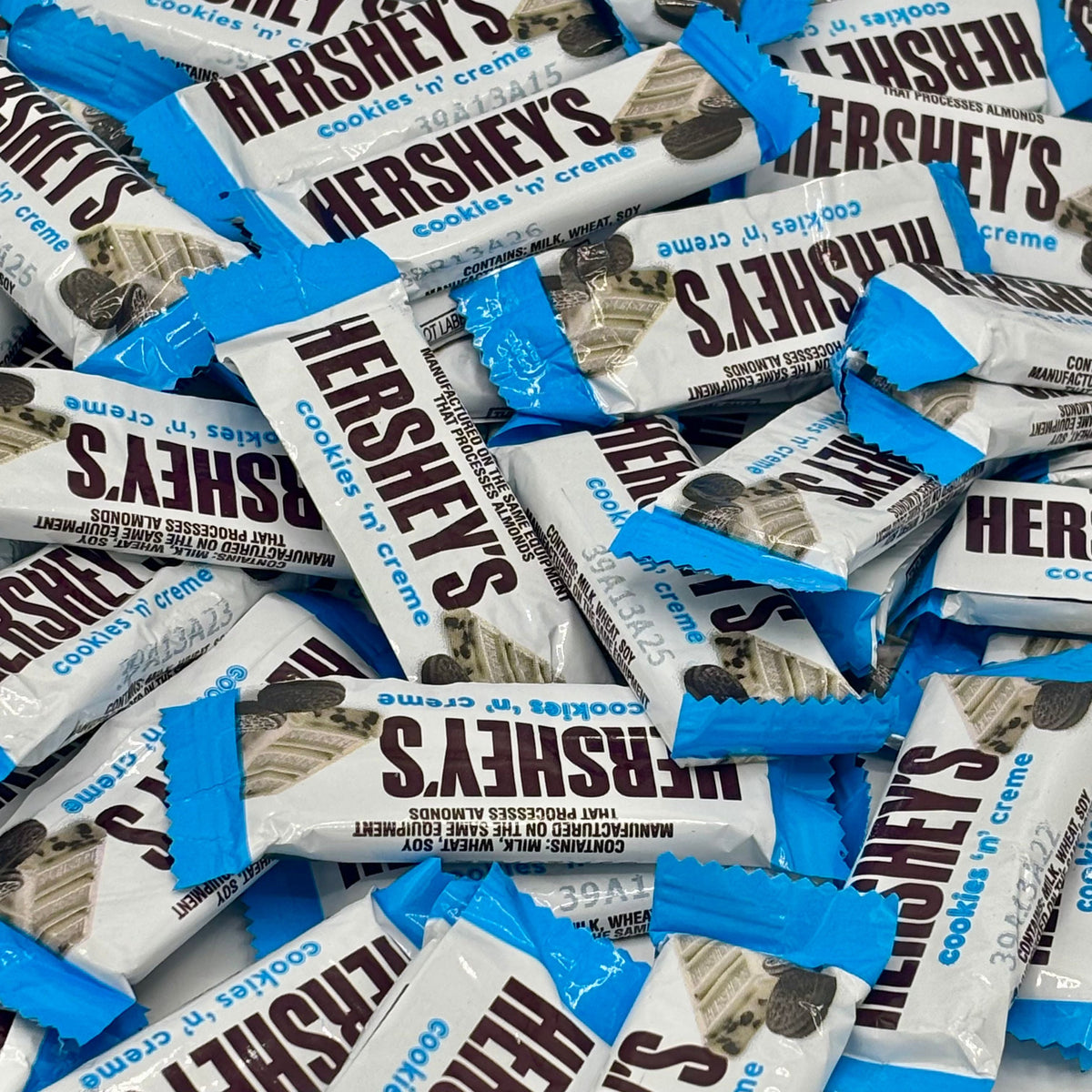 Hershey's Cookies 'n' Creme chocolate snack size candies in a bulk value bag, with creamy filling and cookie pieces visible.