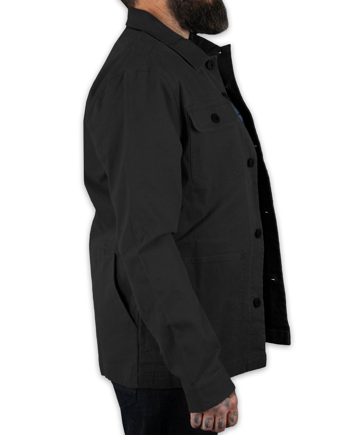 Black Heston Chore Coat jacket by Off The Grid Surplus, featuring durable fabric and classic design, shown in a close-up image.