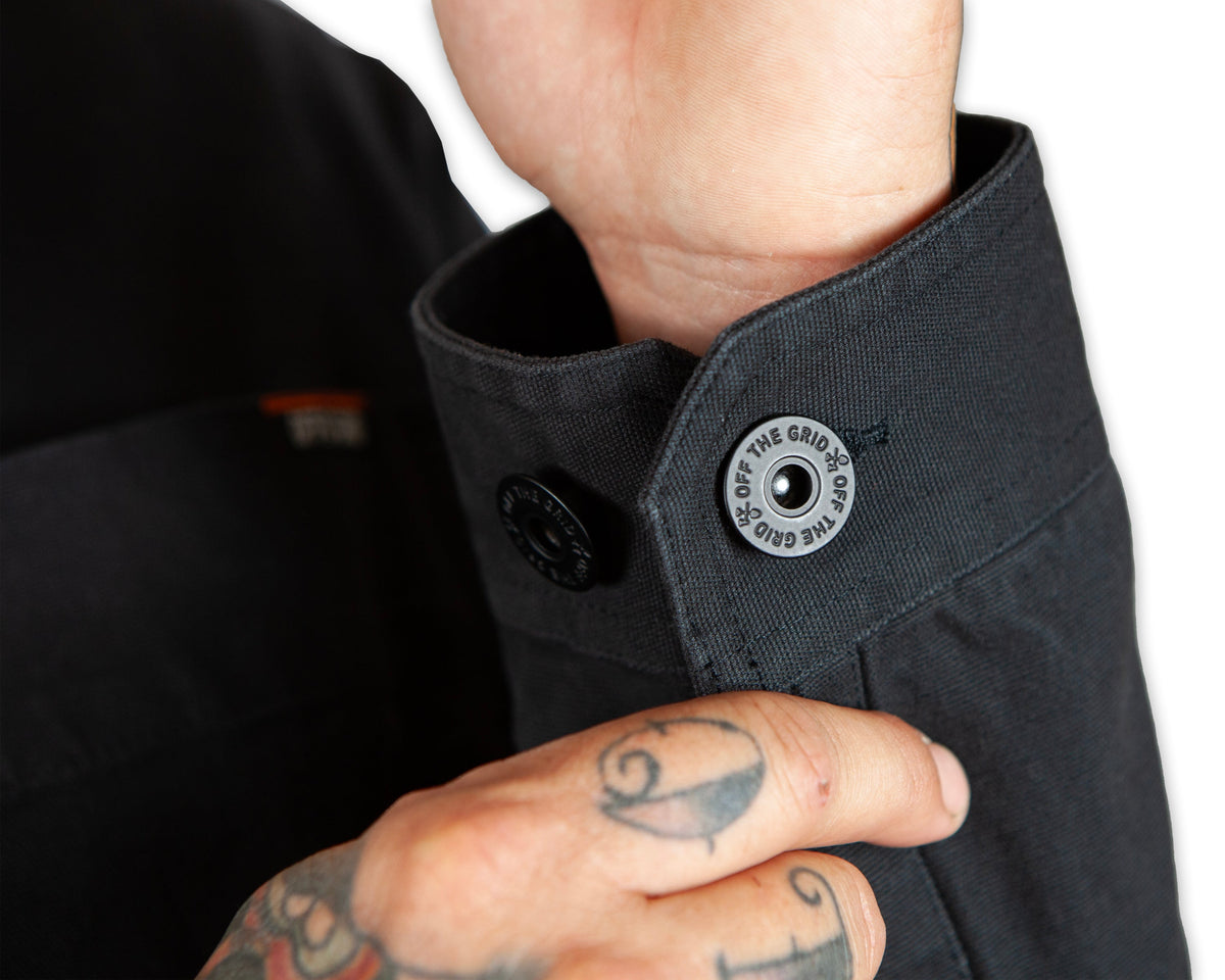 Black Heston Chore Coat jacket by Off The Grid Surplus, featuring durable fabric and classic workwear style.