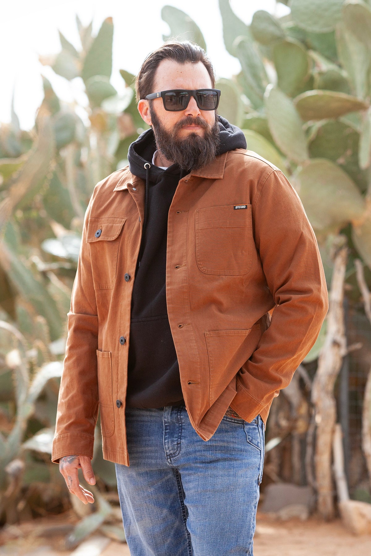 Heston Chore Coat by Off The Grid Surplus in tobacco color, showing a rugged work jacket with multiple pockets and durable fabric.
