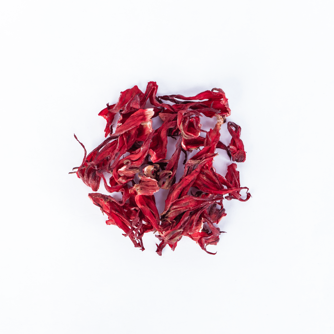 Organic Nepal Tea hibiscus blend with vibrant red hibiscus flowers and leaves, showcasing fresh, natural ingredients for herbal tea.
