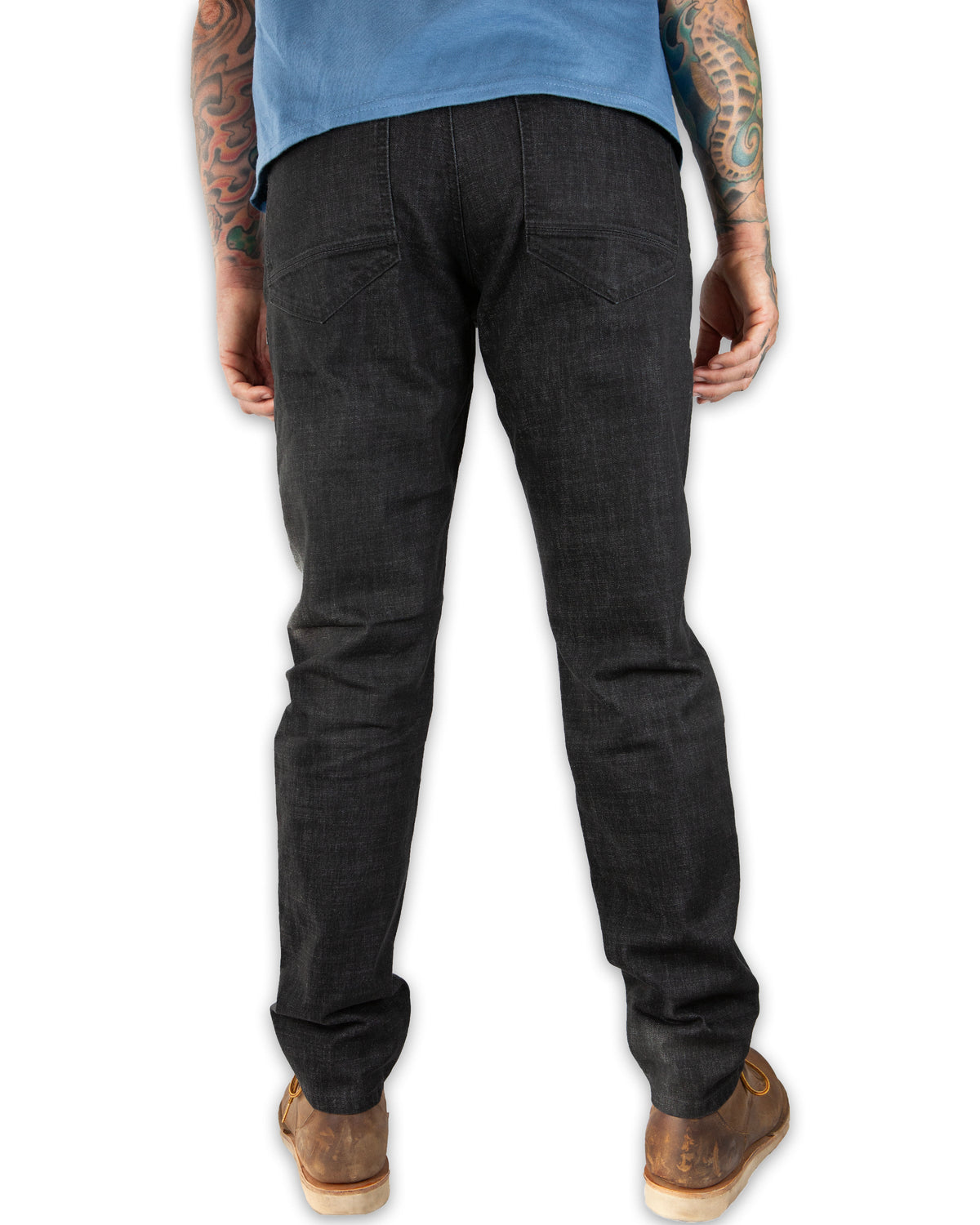 Black Off The Grid Surplus Hideout Denim Taper Fit Pants displayed on a hanger. Slim fit, tapered denim style.