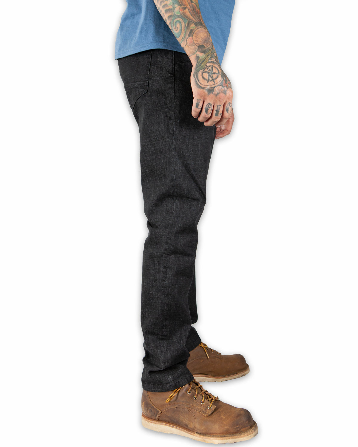 Black denim taper fit pants from Off The Grid Surplus's Hideout collection, shown on a model.