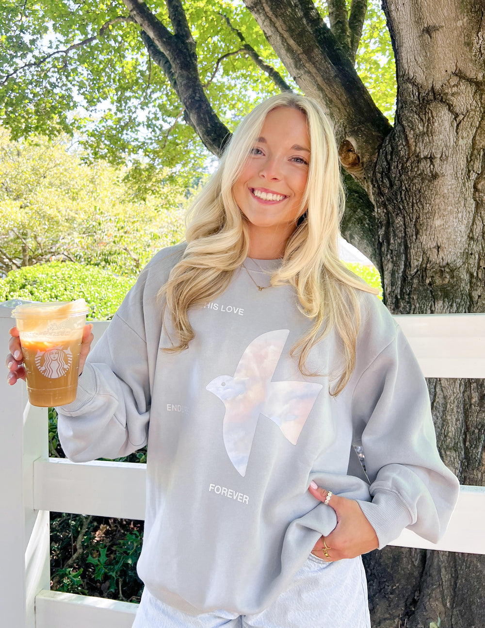 Unisex crewneck sweatshirt with "His Love Endures Forever" printed in white on a gray fabric, from Elevated Faith.