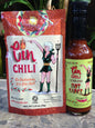 Cinderosa Ranch Cin Chili Seasoning and Serrano Hot Sauce combo in jars with chili peppers and seasoning spices.