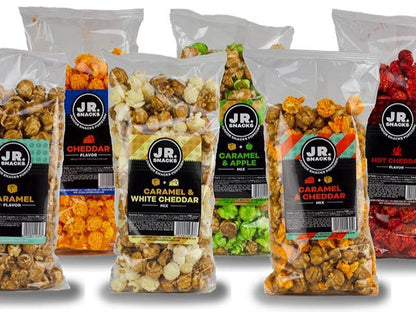 Assorted Junior Snacks from Junior Snacks Company in colorful packaging, displayed on a plain background.