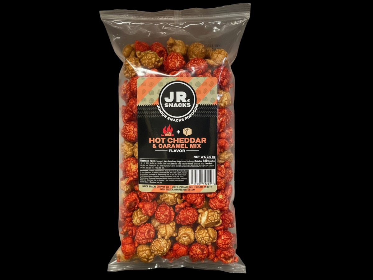 Junior Snacks Hot Cheddar and Caramel Mix in a colorful snack bag with the Junior Snacks Company logo visible.