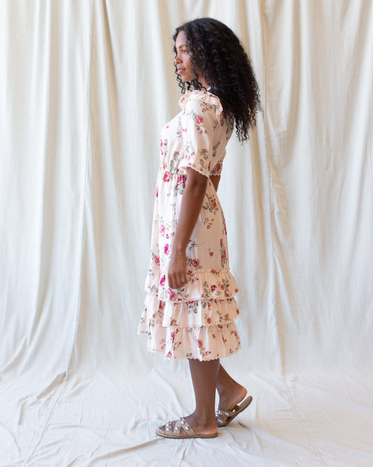 Vintage Romance Dress by Downeast, showing a flowy, floral-patterned dress with lace details on a hanger.