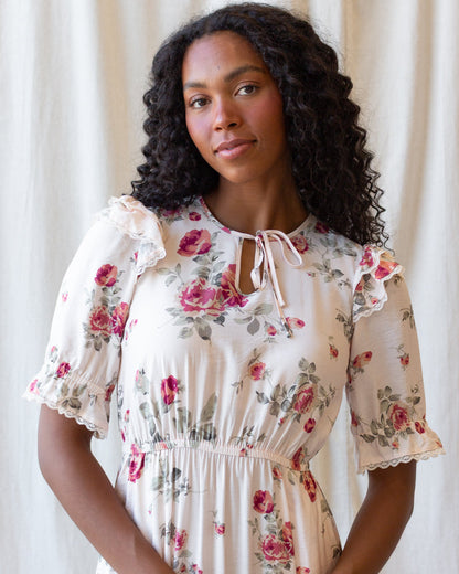 Downeast Vintage Romance Dress displayed on a hanger, featuring lace details, flowing fabric, and a classic, feminine silhouette.