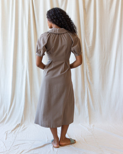 Downeast Femme Field Dress displayed on a hanger, featuring a floral pattern, V-neckline, and long sleeves for casual wear.