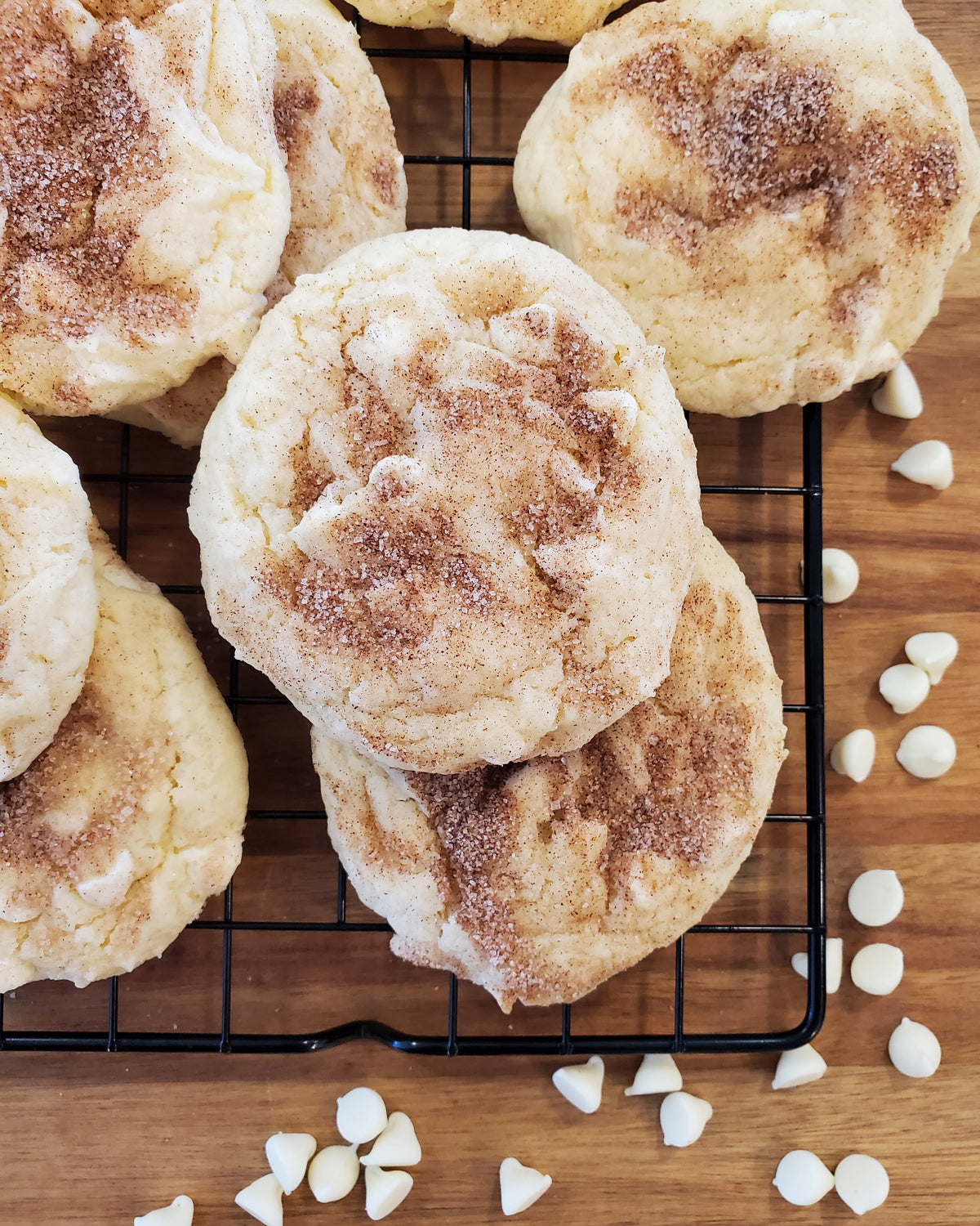White Chocolate Snickerdoodle cookies from Let's Get Baked Artisan Desserts, showing a dozen freshly baked cookies with cinnamon sugar coating.