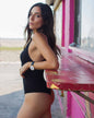 Women's black bodysuit by POS Wholesale, closeout style, featuring a fitted design and scoop neckline.