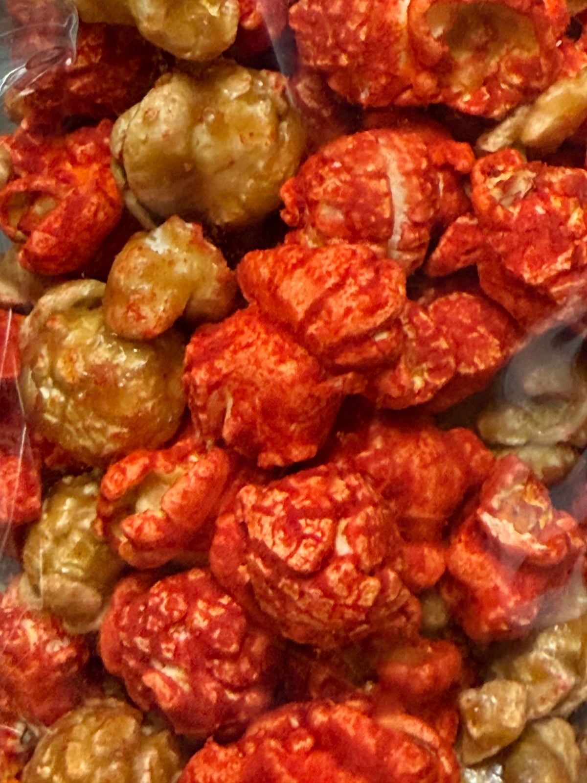 Junior Snacks Hot Cheddar & Caramel Mix in a colorful bowl, showing crunchy snack pieces from Junior Snacks Company.