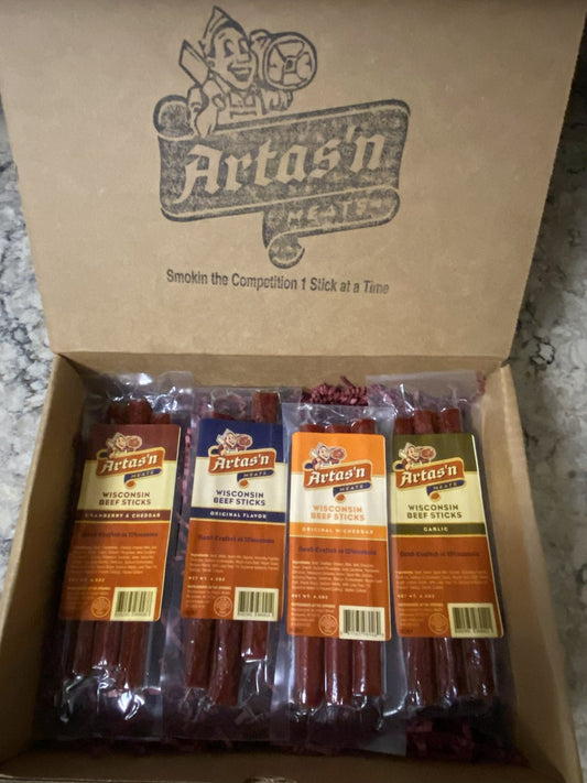 Artas'n Meats Mild 4 Beef Stick Pak in a gift box with four beef jerky sticks on a white background.