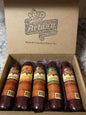 Artas'n Meats Smoke House Five gift box with five assorted sausages on a wooden surface