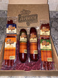 Artas'n Meats Wisconsin Six Pak gift box with assorted sausage sticks arranged inside.