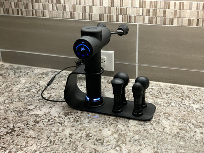 iReliev MVP+ PowerUp charging station for percussion massager accessories, shown with connected attachments and charging ports.