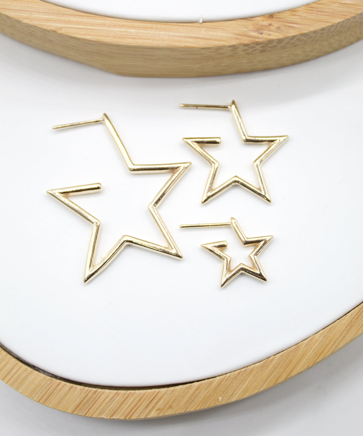 18K gold filled open star hoop earrings by MIA Jewelry, modern minimalist design with small star accents, perfect for everyday wear.