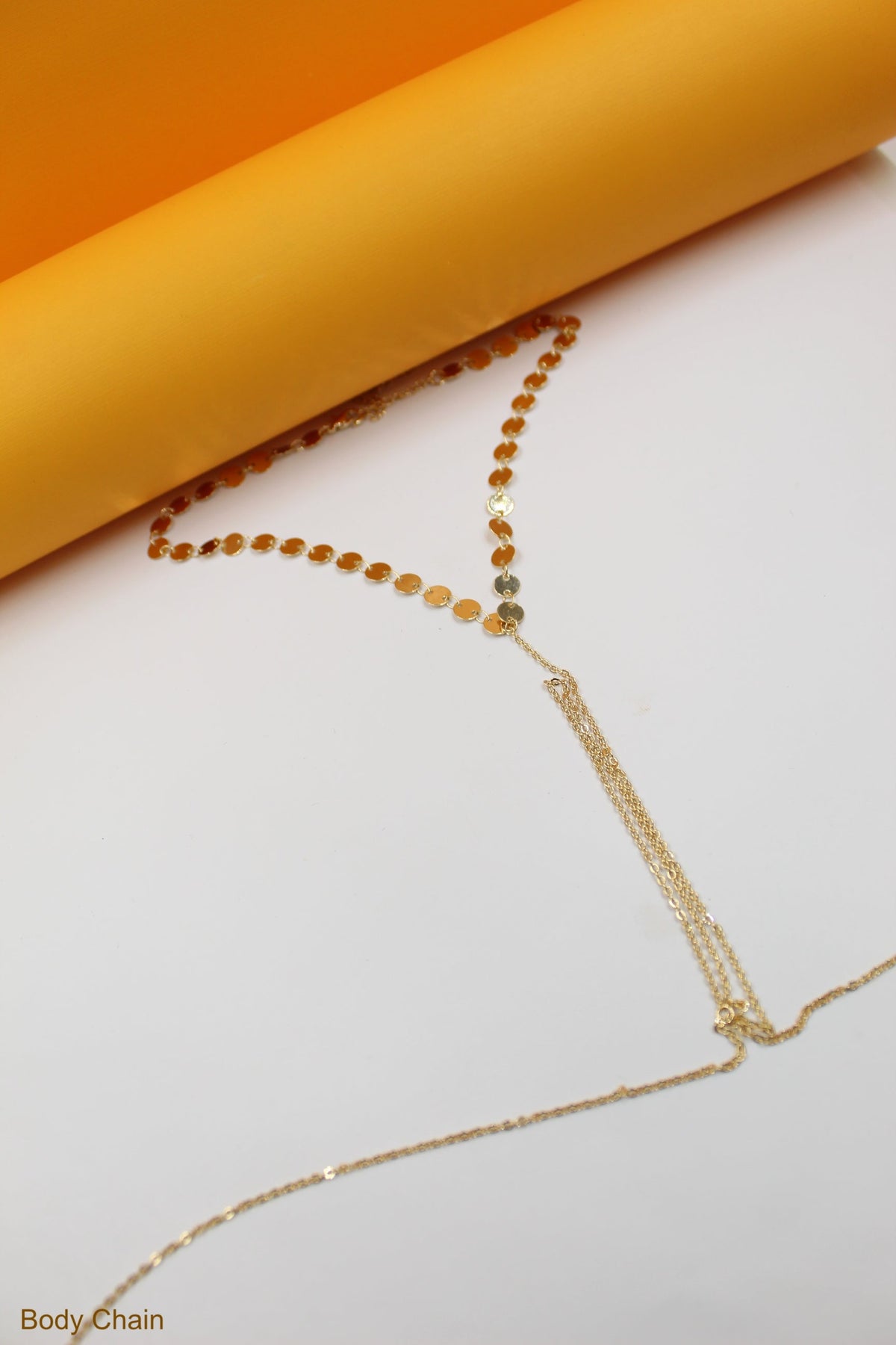 MIA Jewelry body chain harness with round neck discs, featuring a stylish and intricate design on a model.