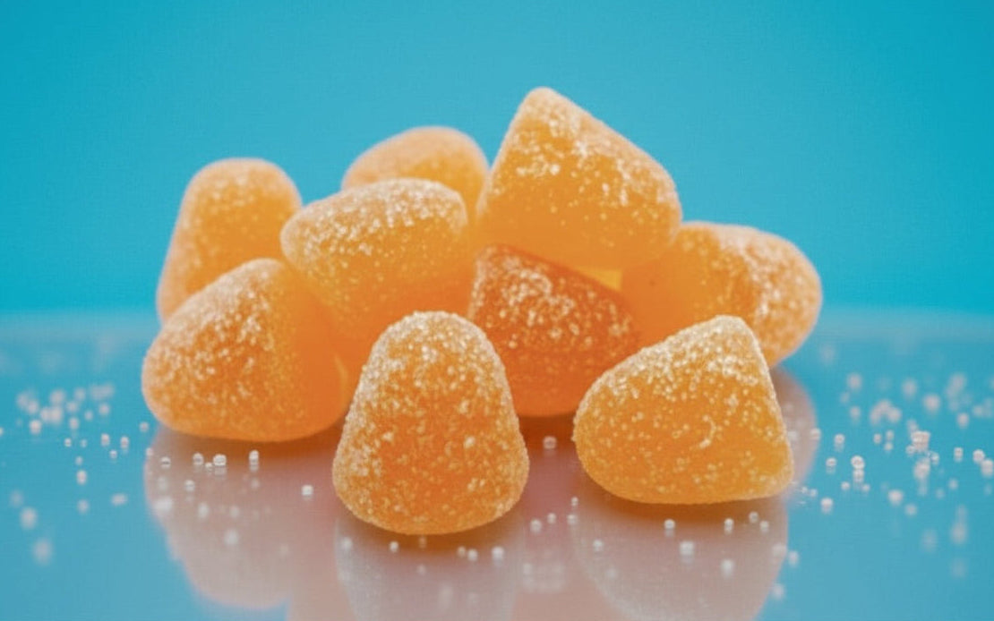 Close-up of Gym Candy Bursts Gain Gummies, colorful chewy fitness supplements in a clear container.