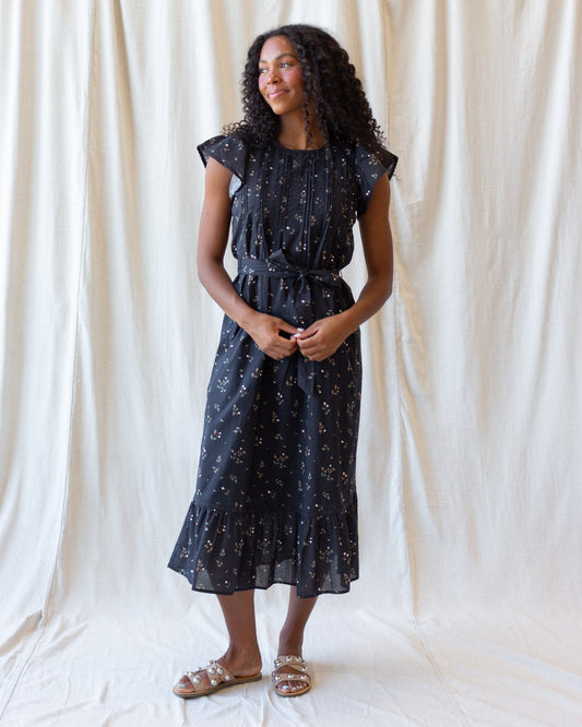 Downeast Pretty Pintuck Dress shown on a model, featuring a flowy silhouette and pintuck details, perfect for casual or semi-formal wear.