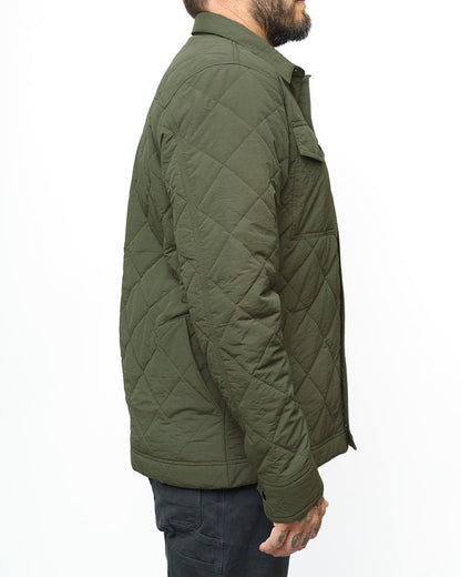 Dark olive Ignite Quilted Jacket by Off The Grid Surplus shown on a model, featuring a quilted design and warm, insulated fabric.