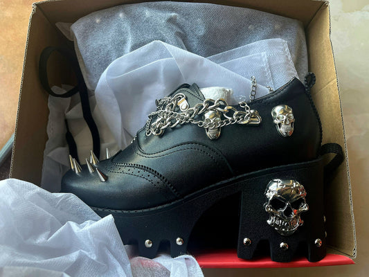 Women's skull shoes with spikes by Don John, featuring bold black design and edgy metal spike accents.