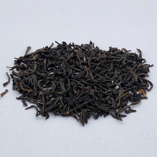 Loose leaf Irish Breakfast black tea in a jar, showcasing dark tea leaves from Novel Tea Book Shop.