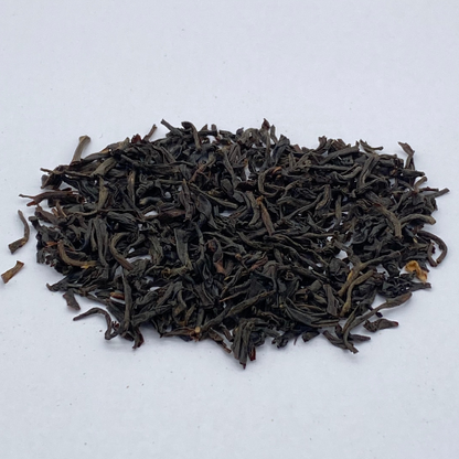 Loose leaf Irish Breakfast black tea in a jar, showcasing dark tea leaves from Novel Tea Book Shop.