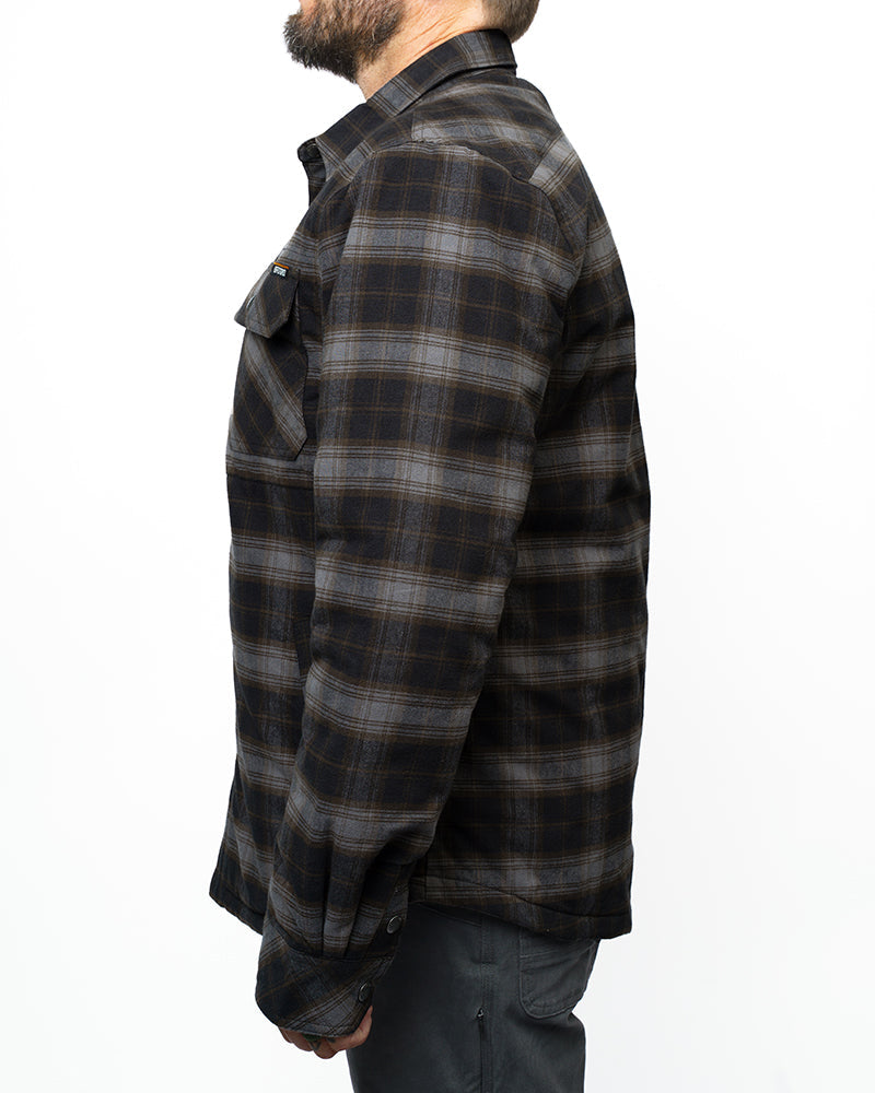 Black Ironside Flannel jacket by Off The Grid Surplus with a relaxed fit, shown hanging on a wooden hanger.